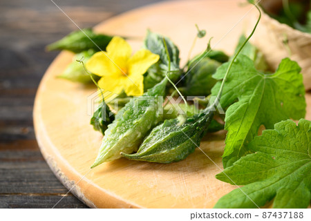 Small bitter gourd or bitter melon on cutting wooden board, Food ingredients and herbal medicine 87437188