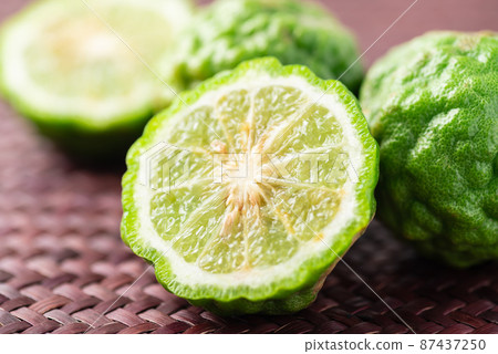 Organic Kaffir lime, Citrus fruit used in Southeast Asian cuisine and essential oil 87437250