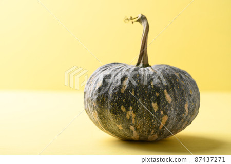 Organic Asian pumpkin on yellow background 87437271