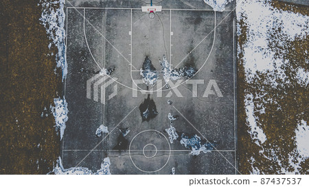 Snow covered park with basketball court Snow covered park with basketball court 87437537