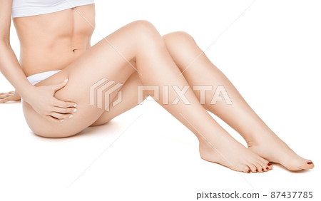 Studio shot of young well shaped woman with a beautiful body sitting on white background 87437785