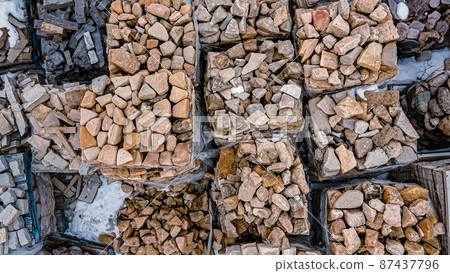 Landscaping rock covered in snow as spring arrives Landscaping rock covered in snow as spring arrives 87437796