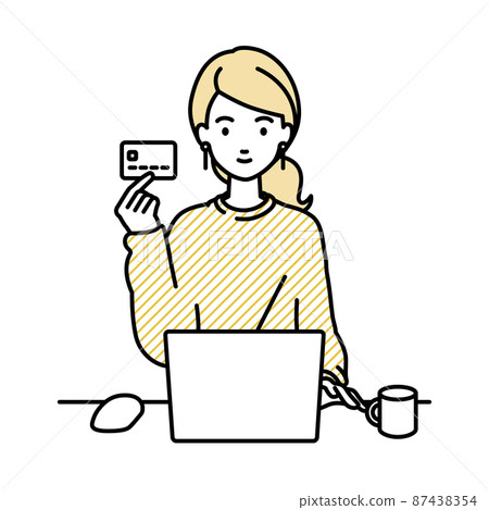 A remote work woman sitting at a desk and using a PC while holding a credit card 87438354