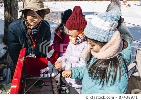 Children making roasted marshmallows at the camp Children making roasted marshmallows at the camp 87438971