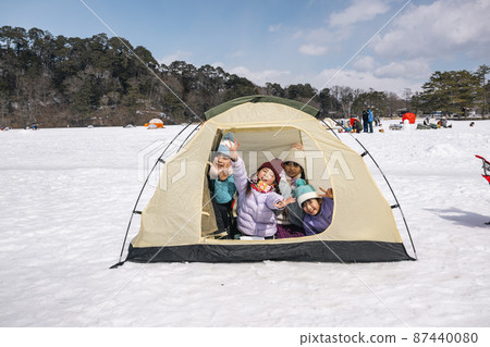 Children in a winter camp tent 87440080