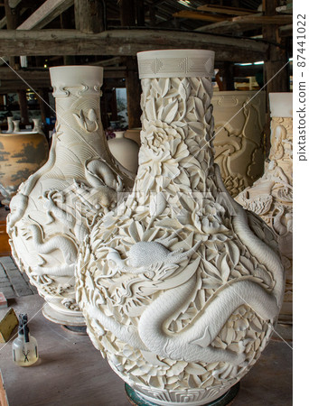 Pottery vases decorated with carved dragon drying in a pottery workshop Pottery vases decorated with carved dragon drying in a pottery workshop 87441022