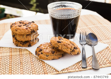 cookies with chocolate and hazelnuts and coffee are on table cookies with chocolate and hazelnuts and coffee are on table 87443749