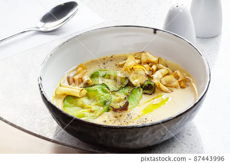 Close-up shot of a delicious cream soup with vegetables, top view. 87443996