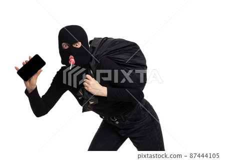 Portrait of young anonymous person wearing black outfit and balaclava isolated on white background. Concept of art, fashion, anti-terrorizm Portrait of young anonymous person wearing black outfit and balaclava isolated on white background. Concept of art, fashion, anti-terrorizm 87444105