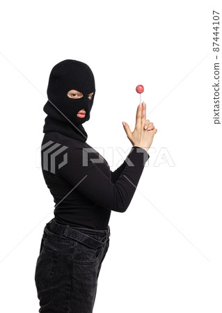 Portrait of young anonymous person wearing black outfit and balaclava isolated on white background. Concept of art, fashion, anti-terrorizm Portrait of young anonymous person wearing black outfit and balaclava isolated on white background. Concept of art, fashion, anti-terrorizm 87444107