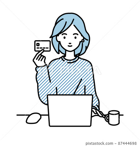 一位遠程工作的女性坐在辦公桌前，一邊拿著信用卡一邊使用電腦 87444698