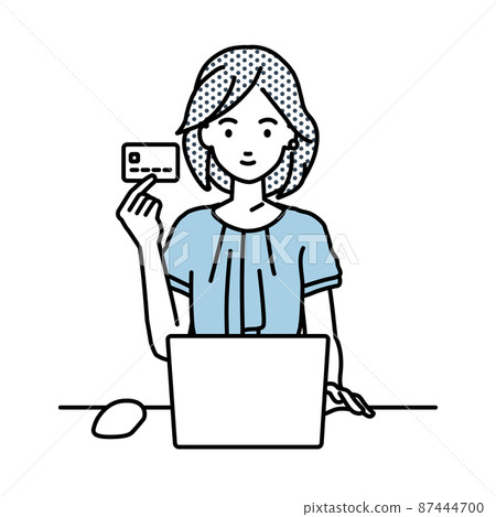 一位辦公室休閒女性坐在辦公桌前，一邊拿著信用卡一邊使用電腦 87444700