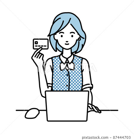 A woman in a clerk uniform sitting at a desk and using a PC while holding a credit card 87444703