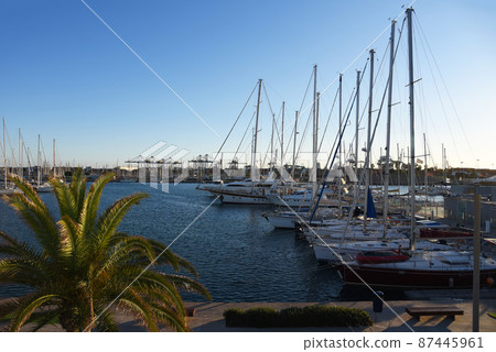 Luxury yacht and fishing motorboat in yacht club on sunset. 87445961