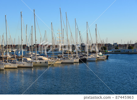 Luxury yacht and fishing motorboat in yacht club on sunset. 87445963