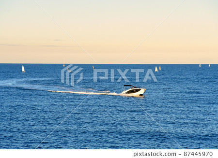 Motor boat in the sea at sunset.Yacht and motorboat on waves in Mediterranean Sea. 87445970