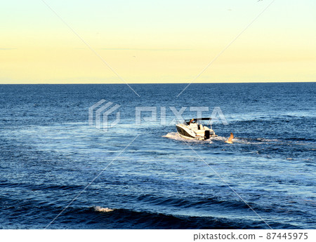 Motor boat in the sea at sunset. Yacht and motorboat on waves in Mediterranean Sea. Motor boat in the sea at sunset. Yacht and motorboat on waves in Mediterranean Sea. 87445975