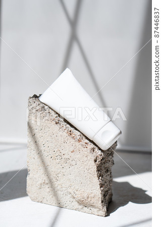 Clean white cream tube with trendy shadows and stone texture Clean white cream tube with trendy shadows and stone texture 87446837