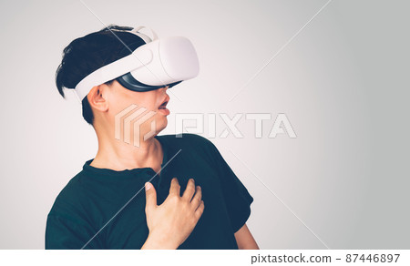 Portrait of young asian man wearing goggles virtual reality with excited isolated. Portrait of young asian man wearing goggles virtual reality with excited isolated. 87446897