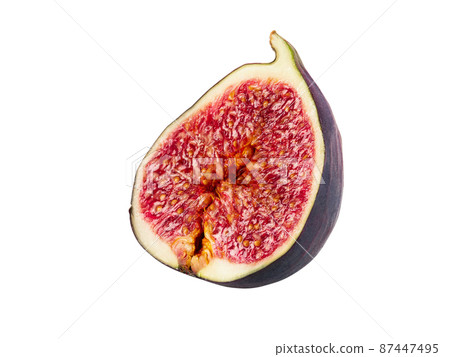Half of a purple fig isolated on white background with copy space. Soft, sweet fruit, skin is thin, red flesh has many seeds inside of it. Close-up. 87447495