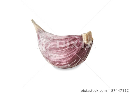 One raw unpeeled clove of garlic, isolated on white background. Vegetable, spice. Ripe summer harvest. Close up, copy space One raw unpeeled clove of garlic, isolated on white background. Vegetable, spice. Ripe summer harvest. Close up, copy space 87447512