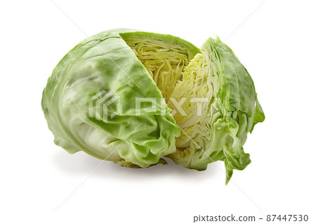Fresh harvested, pale green cabbage and one cut off section. Isolated on white background. Smooth-leafed vegetable. Close up, copy space 87447530
