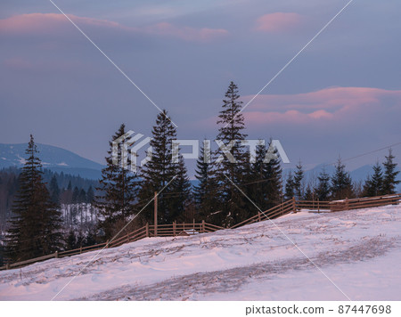 Small alpine village and winter snowy mountains in first sunrise sunlight around, Voronenko, Carpathian, Ukraine. Small alpine village and winter snowy mountains in first sunrise sunlight around, Voronenko, Carpathian, Ukraine. 87447698