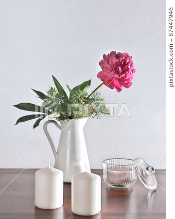 vertical of lifestyle interior decoration pink peony flower with candles on rustic wooden table. cozy home concept. morning light. spring flowers grown in a garden. vertical of lifestyle interior decoration pink peony flower with candles on rustic wooden table. cozy home concept. morning light. spring flowers grown in a garden. 87447946