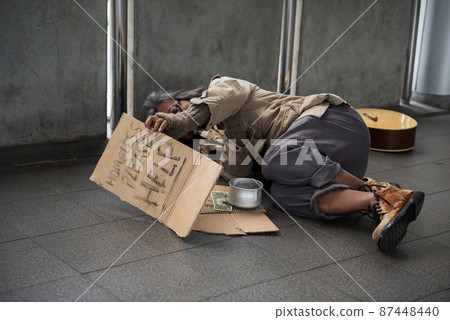 Old Homeless man raise help plate to ask money 87448440