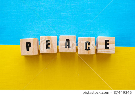 Peace word. Ukraine blue and yellow flag background with inscription on wooden cubes Peace word. Ukraine blue and yellow flag background with inscription on wooden cubes 87449346