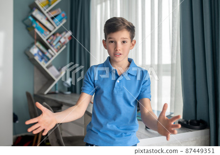 Boy showing his determination and confidence during the communication Boy showing his determination and confidence during the communication 87449351