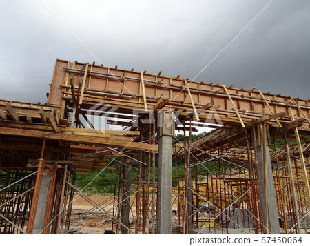 KUALA LUMPUR, MALAYSIA - JULY 7, 2021: Beam and column formwork installed at a construction site. Molds are made of wood and plywood. Be the basis of form to reinforced concrete. 87450064