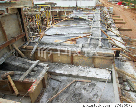 KUALA LUMPUR, MALAYSIA - JULY 7, 2021: Beam and column formwork installed at a construction site. Molds are made of wood and plywood. Be the basis of form to reinforced concrete. KUALA LUMPUR, MALAYSIA - JULY 7, 2021: Beam and column formwork installed at a construction site. Molds are made of wood and plywood. Be the basis of form to reinforced concrete. 87450073