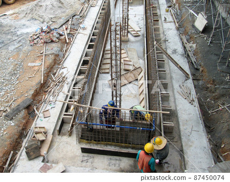 KUALA LUMPUR, MALAYSIA - JULY 7, 2021: Beam and column formwork installed at a construction site. Molds are made of wood and plywood. Be the basis of form to reinforced concrete. 87450074