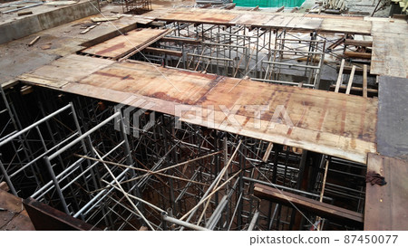KUALA LUMPUR, MALAYSIA - JULY 7, 2021: Beam and column formwork installed at a construction site. Molds are made of wood and plywood. Be the basis of form to reinforced concrete. 87450077