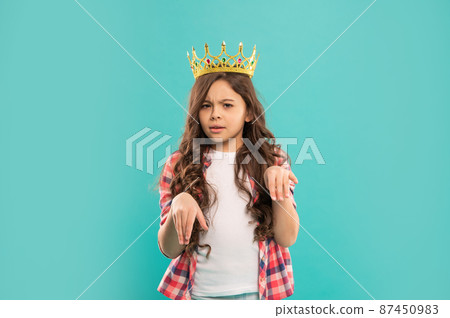 arrogant kid with curly hair in princess crown on blue background, arrogance arrogant kid with curly hair in princess crown on blue background, arrogance 87450983