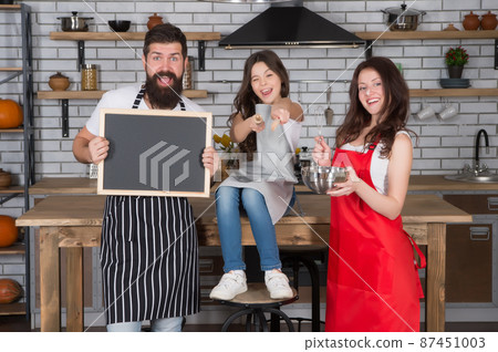 Family little daughter chalkboard recipe copy space at kitchen, baking cake concept Family little daughter chalkboard recipe copy space at kitchen, baking cake concept 87451003