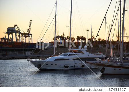 Yacht and fishing motorboat in yacht club on sunset 87451527