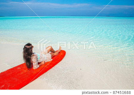 Woman surfing in the sea on vacation Woman surfing in the sea on vacation 87451688