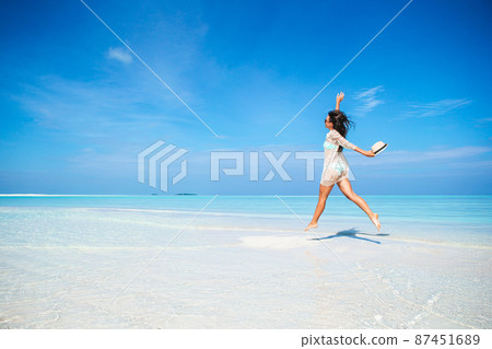Young fashion woman in dress on the beach Young fashion woman in dress on the beach 87451689