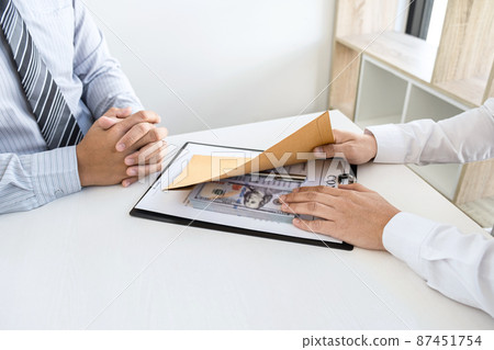 Dishonest cheating in business illegal money, Businessman giving bribe money in business people to accept agreement contract of investment deal, Bribery and corruption concept 87451754