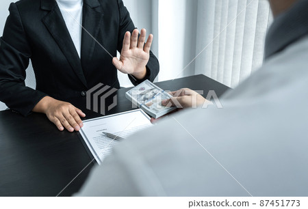 Business woman refusing and don't receive money banknote in envelope offer from business people to accept agreement contract of investment deal 87451773