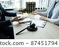 Male lawyer working on documents contract papers of the important case with the business customer and wooden gavel, brass scale in office 87451794
