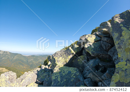 Rocky mountain hillside with big stone boulders on sunny day 87452412