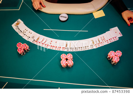 Player chips and the start of poker hands. 87453398