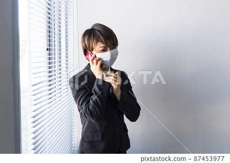 A woman wearing a mask who offers a fictitious transaction A woman wearing a mask who offers a fictitious transaction 87453977