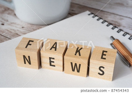 Image of fake news | Building blocks, pens, notebooks, cups with "FAKE" and "NEWS" written on them 87454343