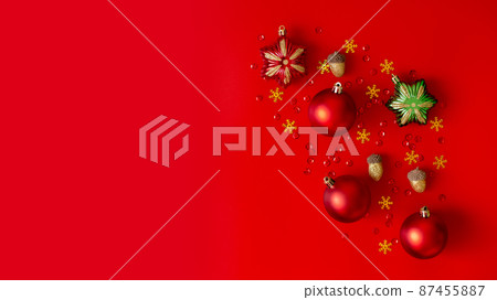 Wide Christmas composition. Christmas red, gold and green decorations on red background. Wide Christmas composition. Christmas red, gold and green decorations on red background. 87455887