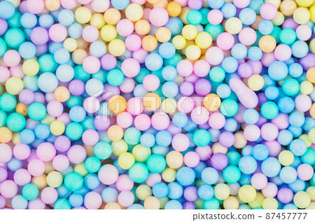 Foam beads of various colors brightly colored background. Foam beads of various colors brightly colored background. 87457777
