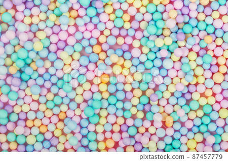 Foam beads of various colors brightly colored background. Foam beads of various colors brightly colored background. 87457779